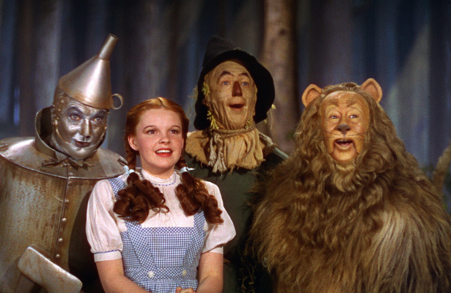 The Tin Man, Dorothy, The Scarecrow, and The Cowardly Lion in The Wizard of Oz.