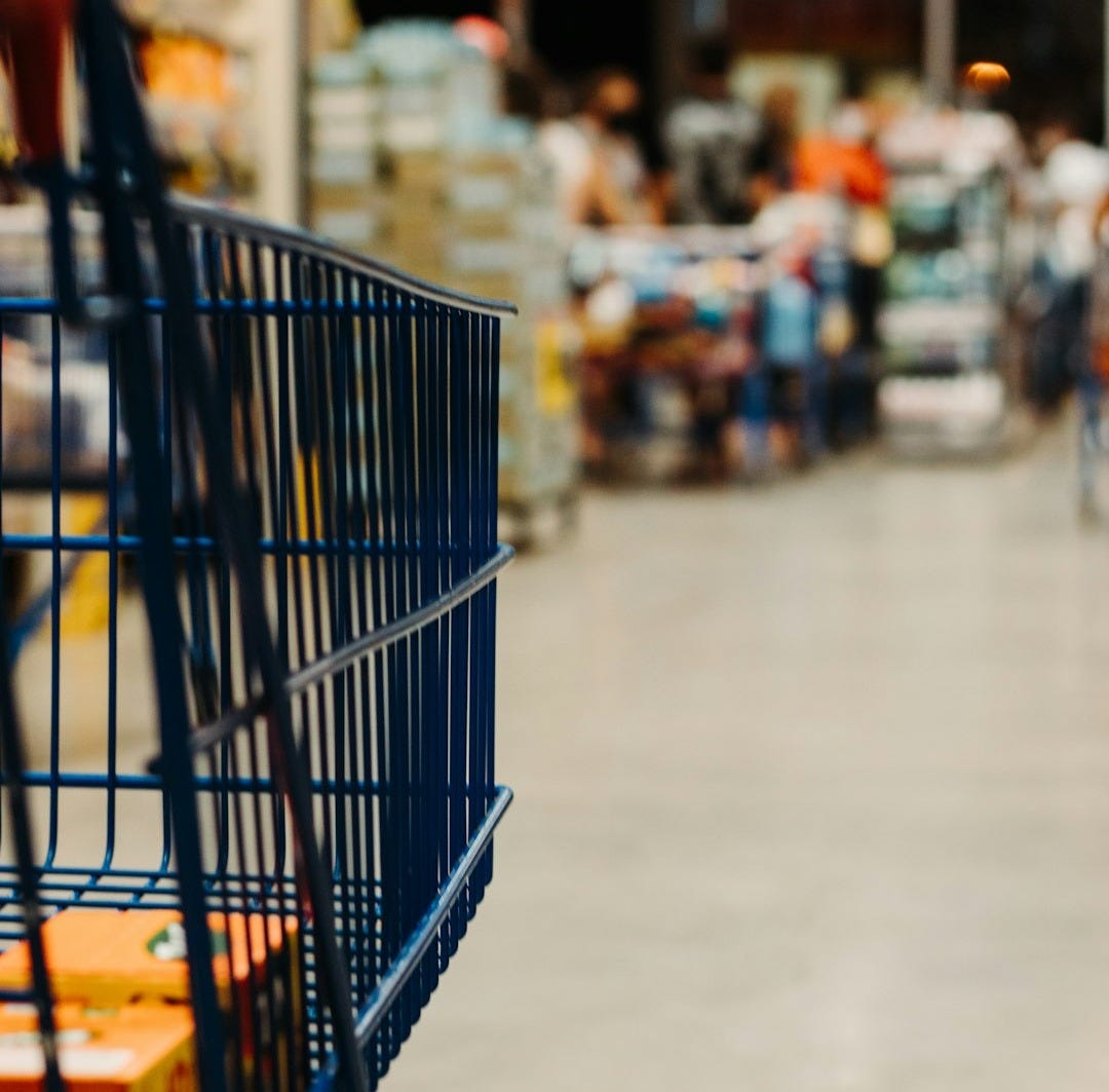 blue shopping cart on street during daytime