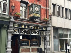 Outside O'Neill's: sign & clock