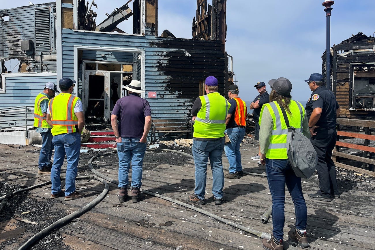 Oceanside engineers and firefighters assess the fire damage on Oceanside Pier. Construction crews will be work on removing the debris on Monday. Photo courtesy Terry Gorman Brown, city of Oceanside