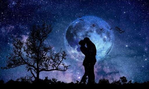 Couple kissing in front of the moon