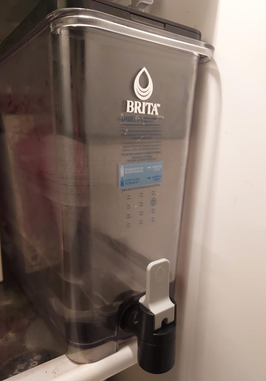 A close-up of a Brita filter in a refrigerator.