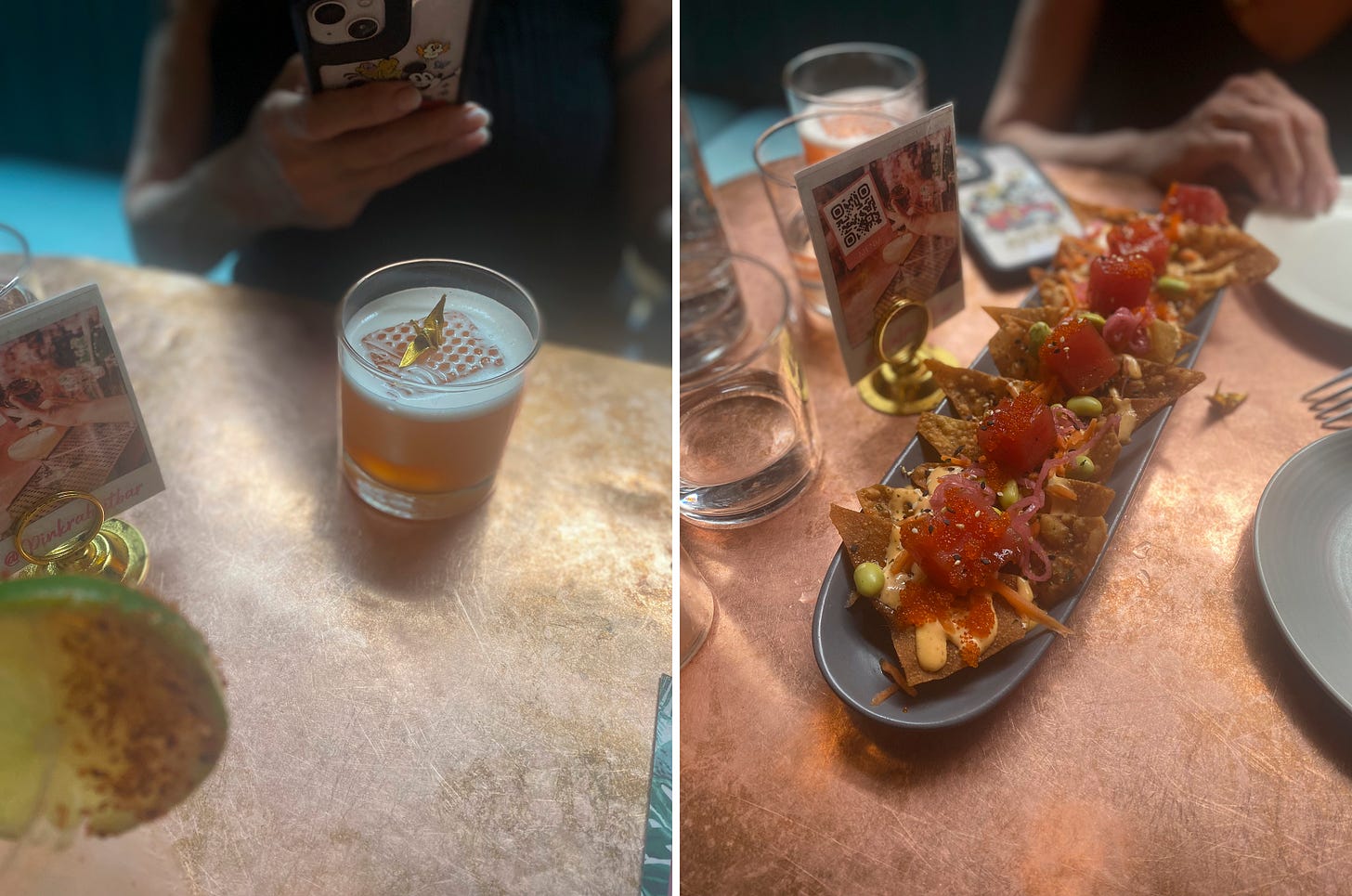 left image: a rocks glass with an orange-brown cocktail in it, a large stamped ice cube in the centre with a gold origami bird on top. My mom is taking a picture with her phone. Right image: a long serving dish of the ahi tobiko nachos, which are crisp wonton chips with spiy mayo, cubes of tuna sashimi, pickled onion, edamame, and tobiko. 