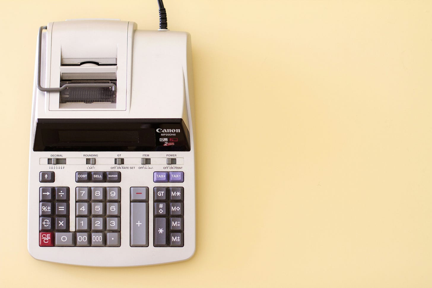 Picture of an adding machine on a cream colored background. Picture of an adding machine on a cream colored background.