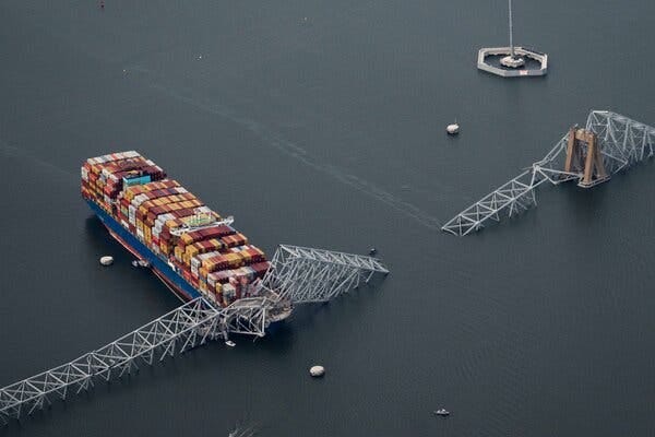 A cargo ship collided with a bridge. The bridge is submerged in water.