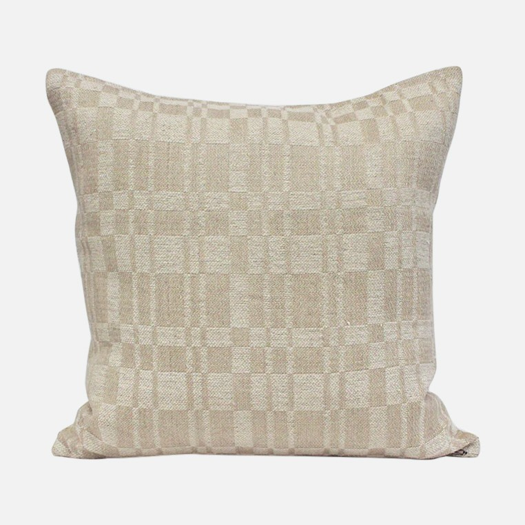 a beige pillow with a checkered pattern on it