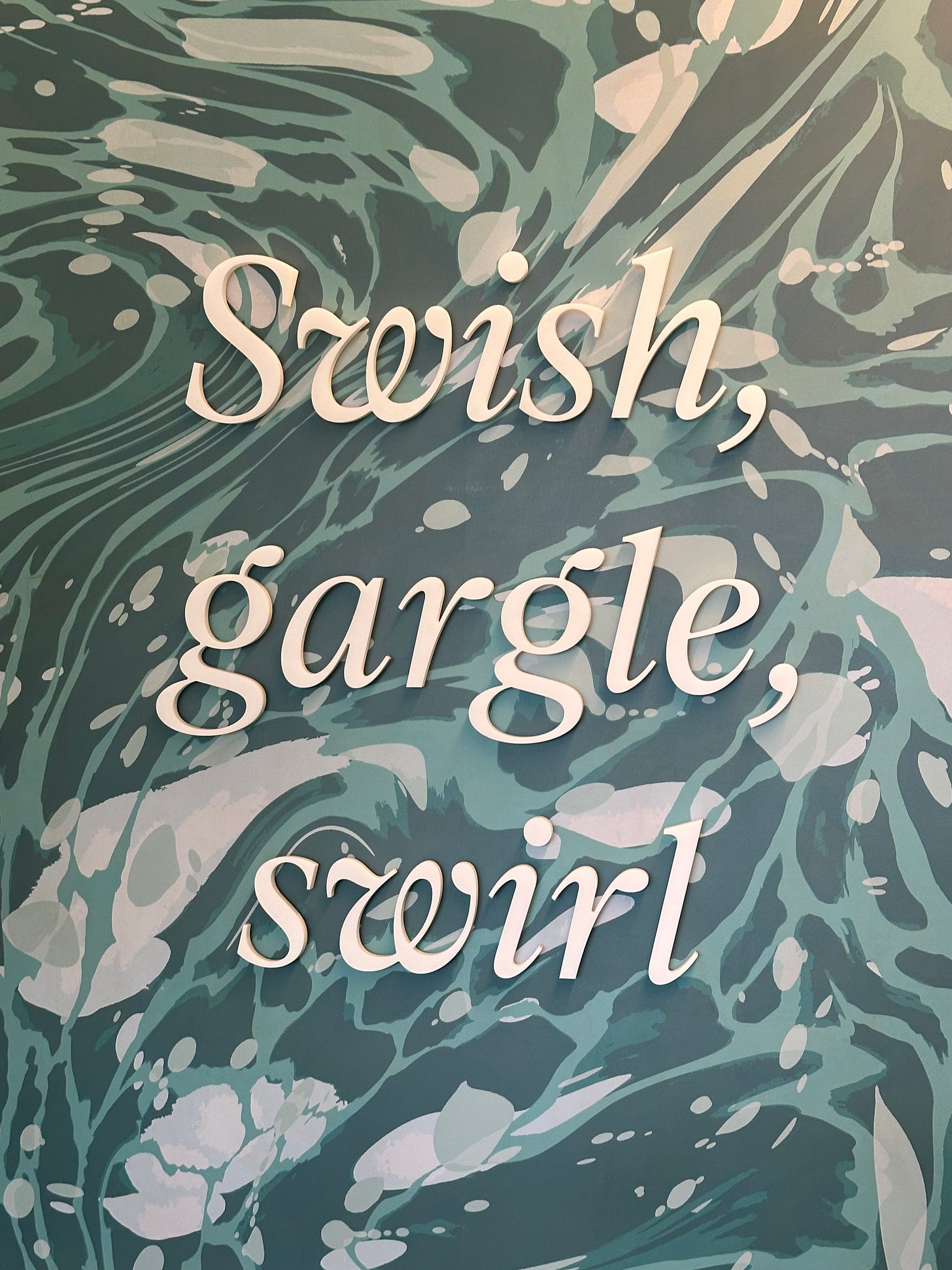 "Swish, gargle, swirl" office artwork.