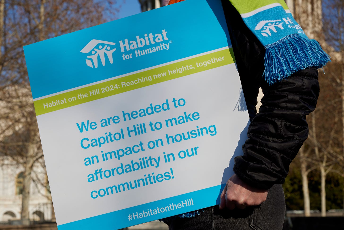 Sign that says "We are headed to Capitol Hill to make an impact on housing affordability in our communities". 