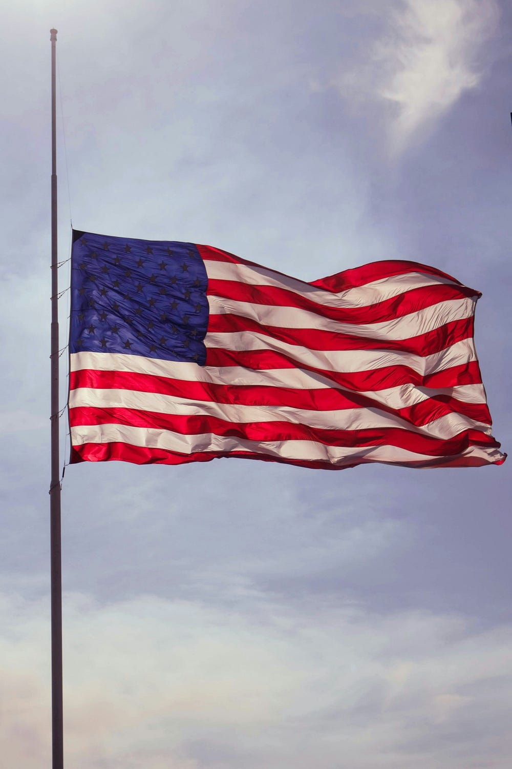 An American flag being flown at half mast.