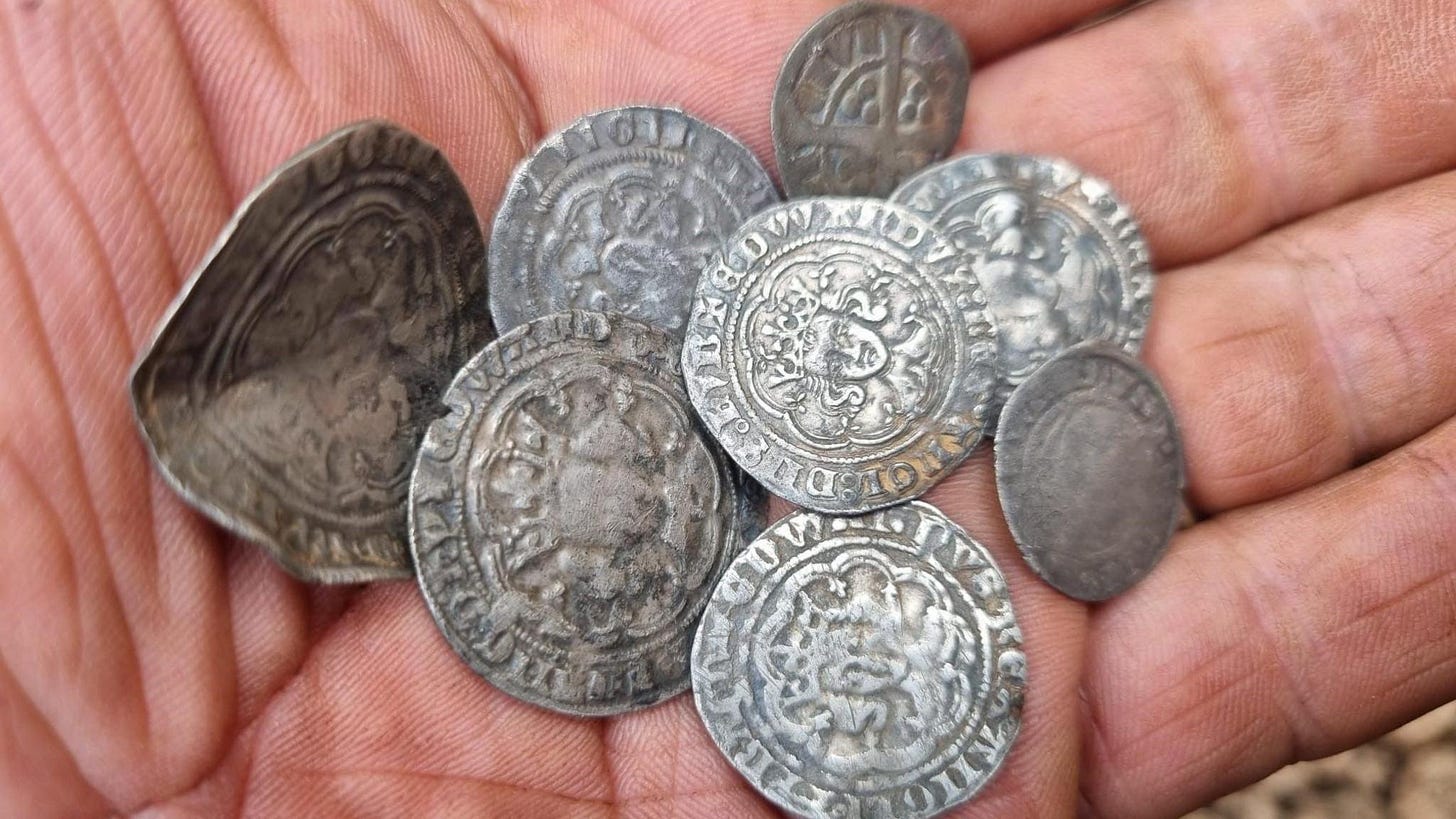 Metal detectorist unearths eight silver coins in Derbyshire field - BBC News