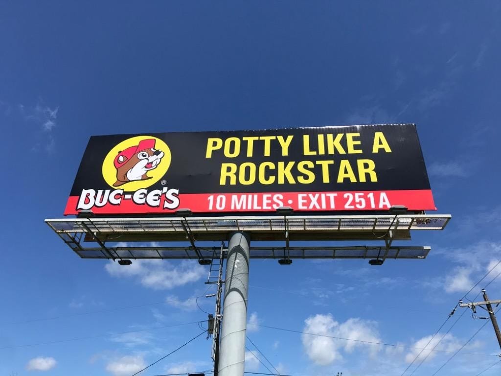 A Buc-ee’s billboard saying POTTY LIKE A ROCKSTAR - it's a play on words for PARTY LIKE A ROCKSTAR