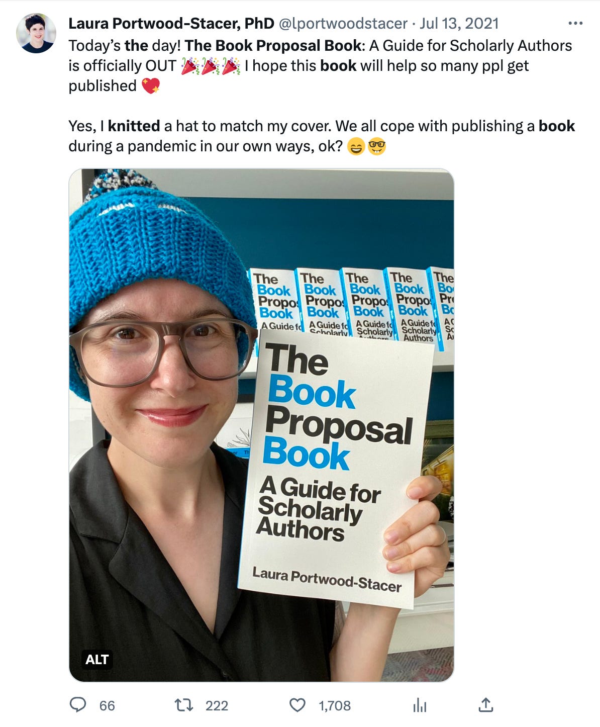 A screenshot of my tweet announcing the publication of The Book Proposal Book and picturing me wearing a beanie knitted in the same colors as the book's cover (black, white, and electric blue)