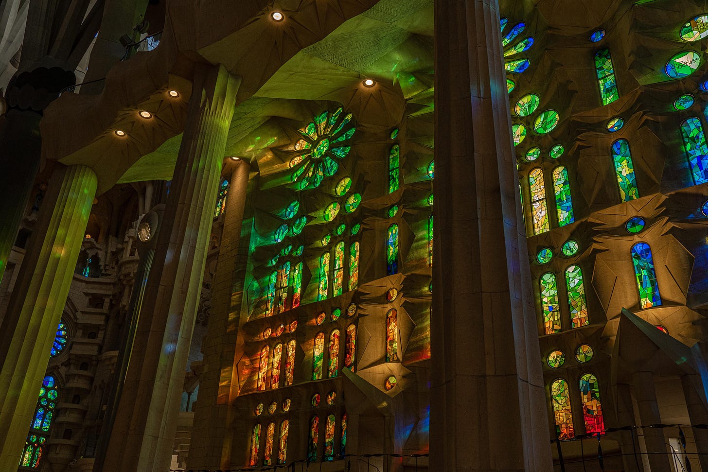 Windows of the Sagrada Familia, bleeding light in every imaginable color over gray stone.