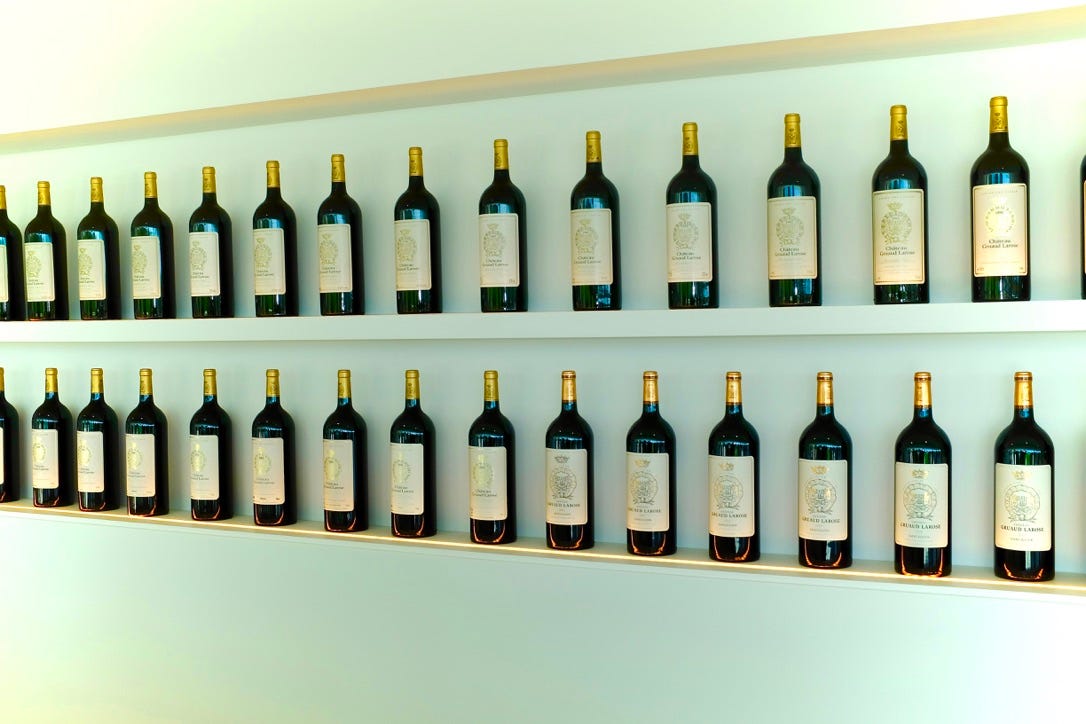 A row of wine bottles on a shelf

Description automatically generated