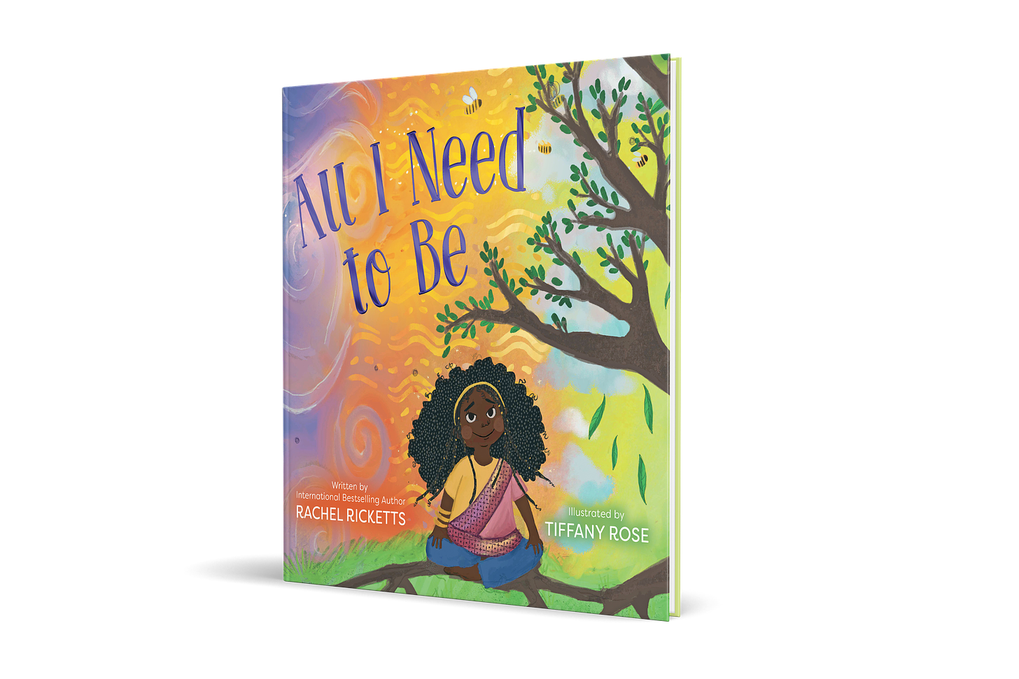 image of front cover of Rachel's kids book ALL I NEED TO BE with an orange & purple swirly background, a young Black girl sits cross legged under a tree with an afro, jeans, t-shirt and sari on.