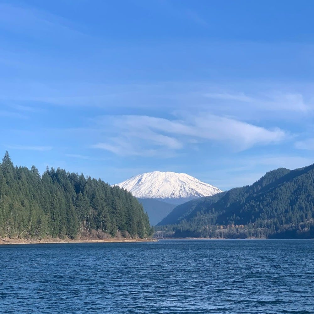 a large body of water with a mountain in the background