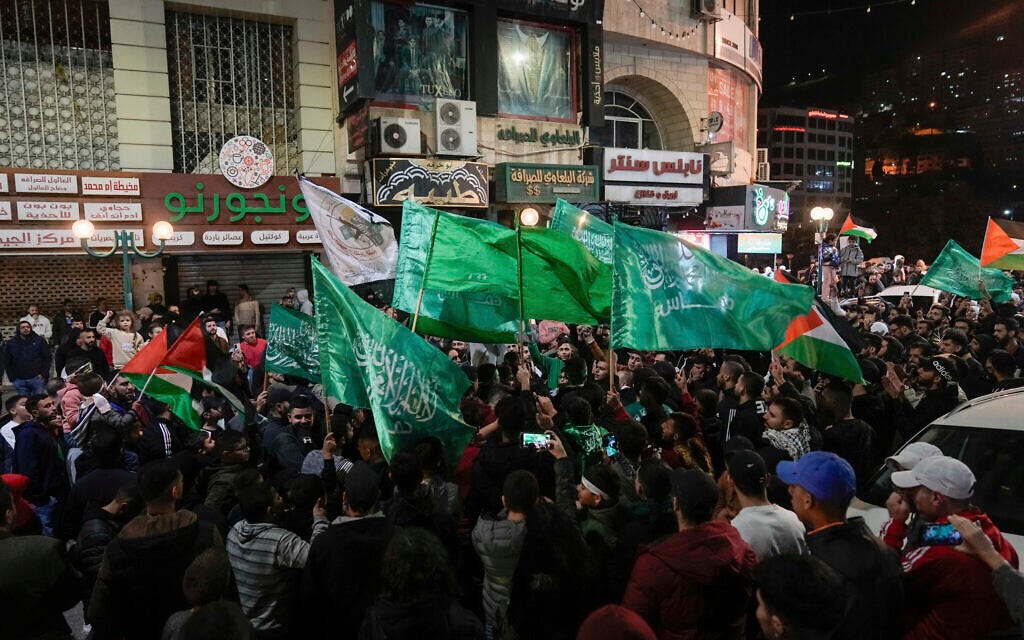 Palestinians wave Hamas flags as they celebrate the release of Palestinian prisoners in Nablus in the West Bank, Nov. 24, 2023. (AP Photo/Majdi Mohammed)