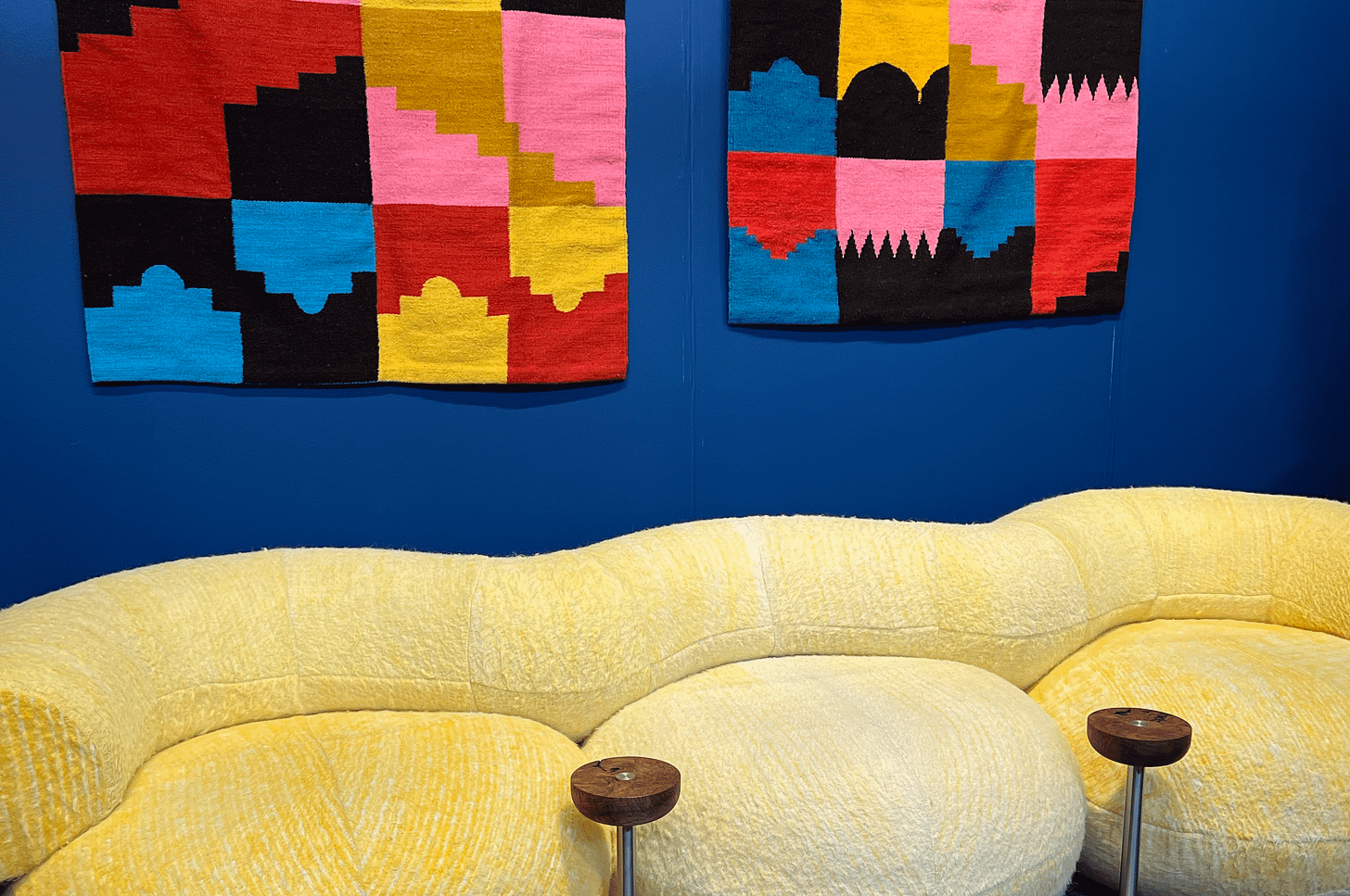 yellow bubble sofa and colorful weaved art 