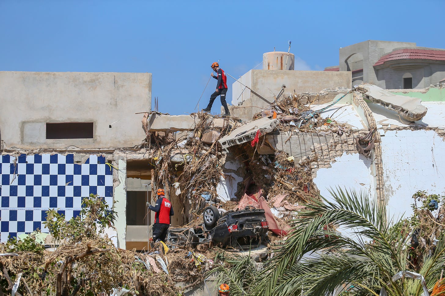 Turkiye’s State Disaster and Emergency Management Authority, along with the teams from Russia, Spain, Italy, Tunisia, Algeria and UAE conduct search and rescue operations in the aftermath of severe flooding caused by Storm Daniel in Derna, Libya on Sept. 19, 2023. Credit: Halil Fidan/Anadolu Agency via Getty Images