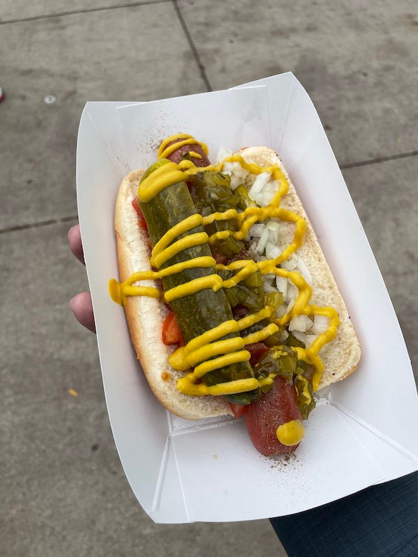 A Chicago dog, with mustard, relish, onions, tomatoes, dill pickle, sport peppers, and celery salt