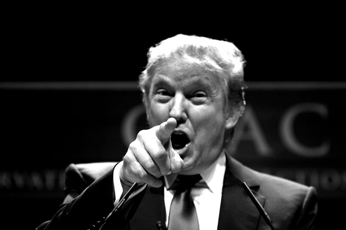 A person in a suit pointing his fingerAI-generated content may be incorrect.