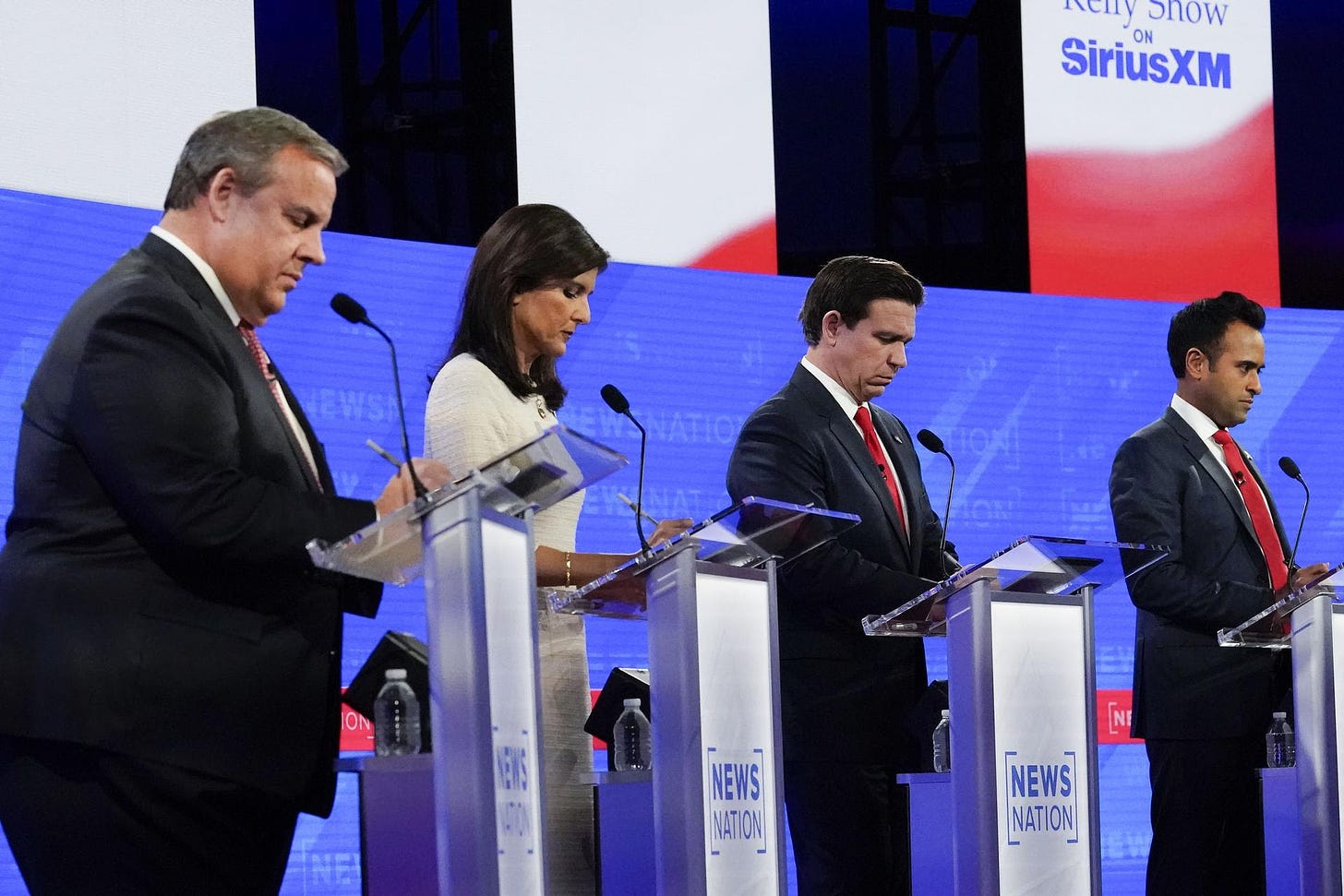Candidates stand on stage during a Republican presidential primary debate.