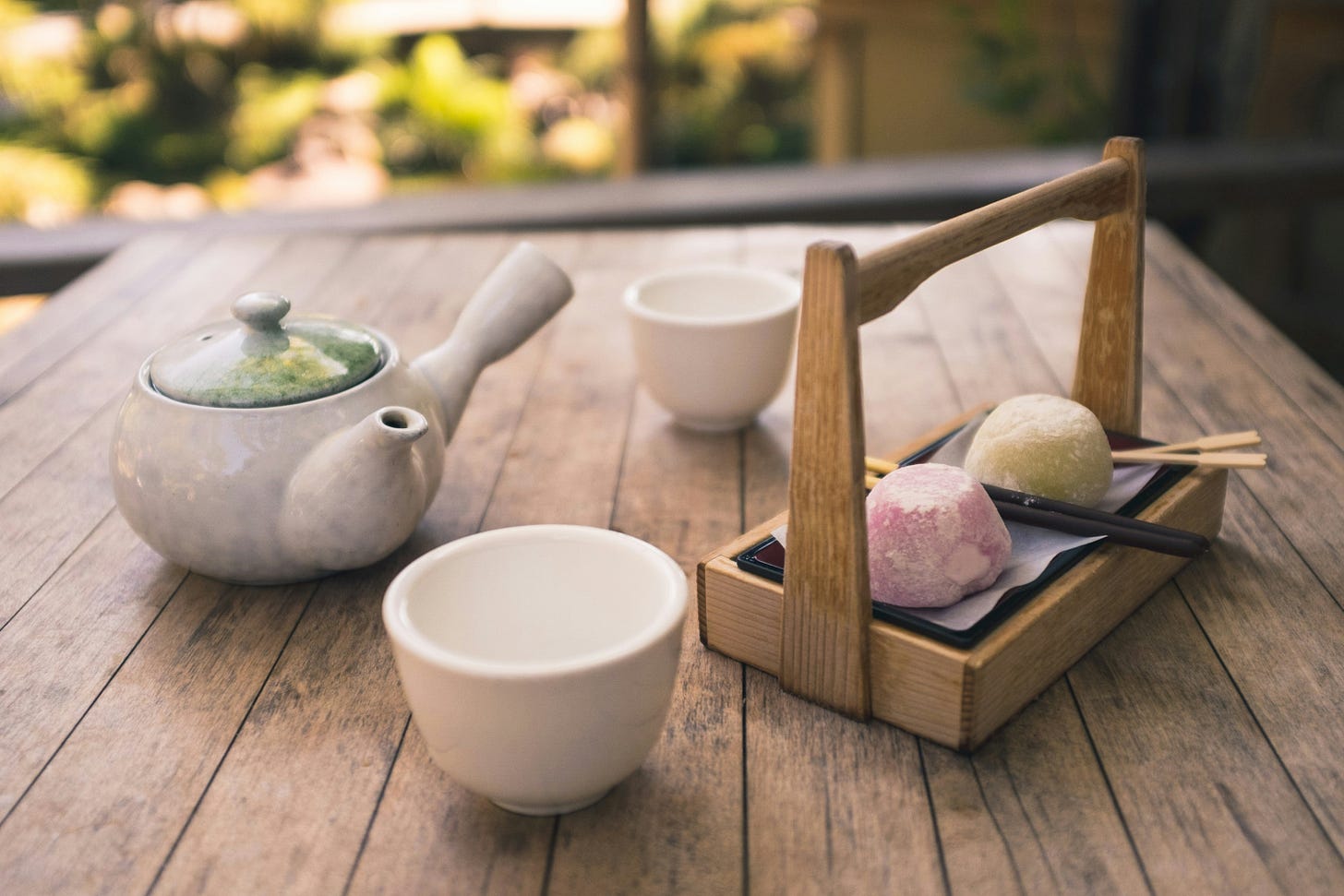 Teapot and cups on table in Japanese tea garden