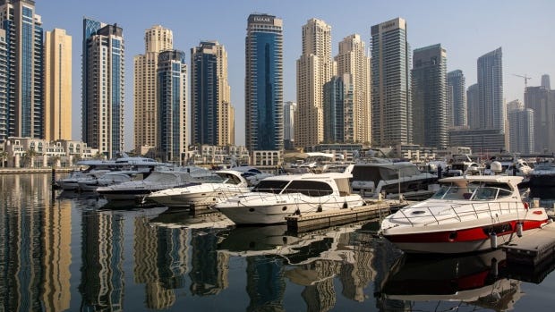 Residential skyscraper buildings beyond motor yachts docked in the Dubai Marina district of Dubai, United Arab Emirates, on Friday, Aug. 25, 2023. Chinese investors are gradually returning to Dubai’s real estate market, joining Russian and other international buyers who have already pushed property prices in the emirate to record levels. Photographer: Christopher Pike/Bloomberg