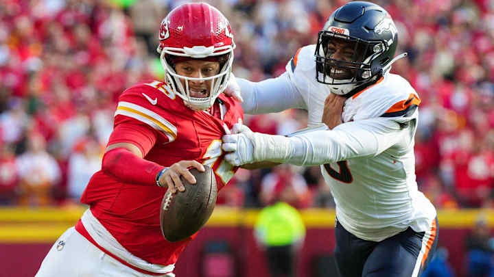 Nov 10, 2024; Kansas City, Missouri, USA; Kansas City Chiefs quarterback Patrick Mahomes (15) runs the ball against Denver Broncos linebacker Jonathon Cooper (0) during the second half at GEHA Field at Arrowhead Stadium. 