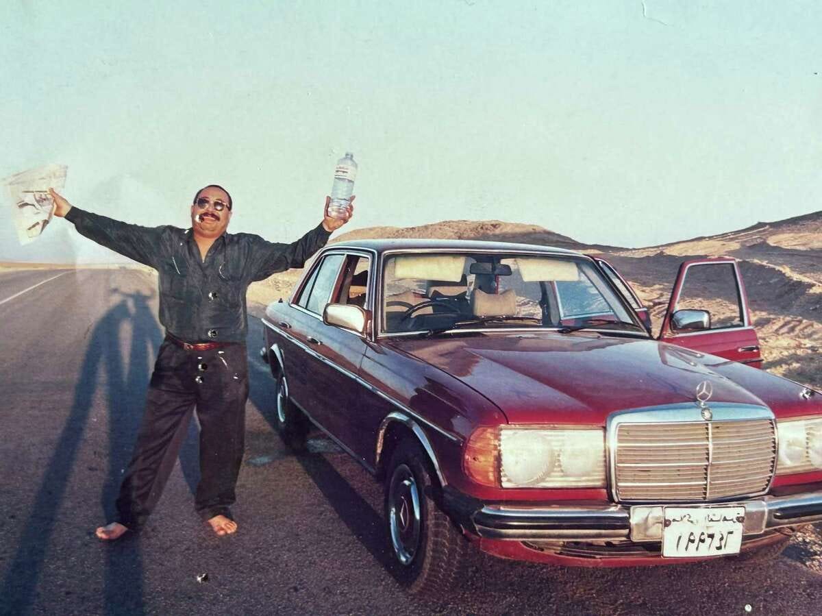 Moustafa Bassiouni stands next to his Mercedes Benz sedan during a break in a long drive from Cairo to Sharm El Sheik in the Sinai peninsula in 1997. Bassiouni, an intrepid photo assistant and driver for The Associated Press’ Cairo bureau, has died at age 64. His family said he died in a Cairo hospital on Saturday, June 10, 2023, after experiencing a heart attack.