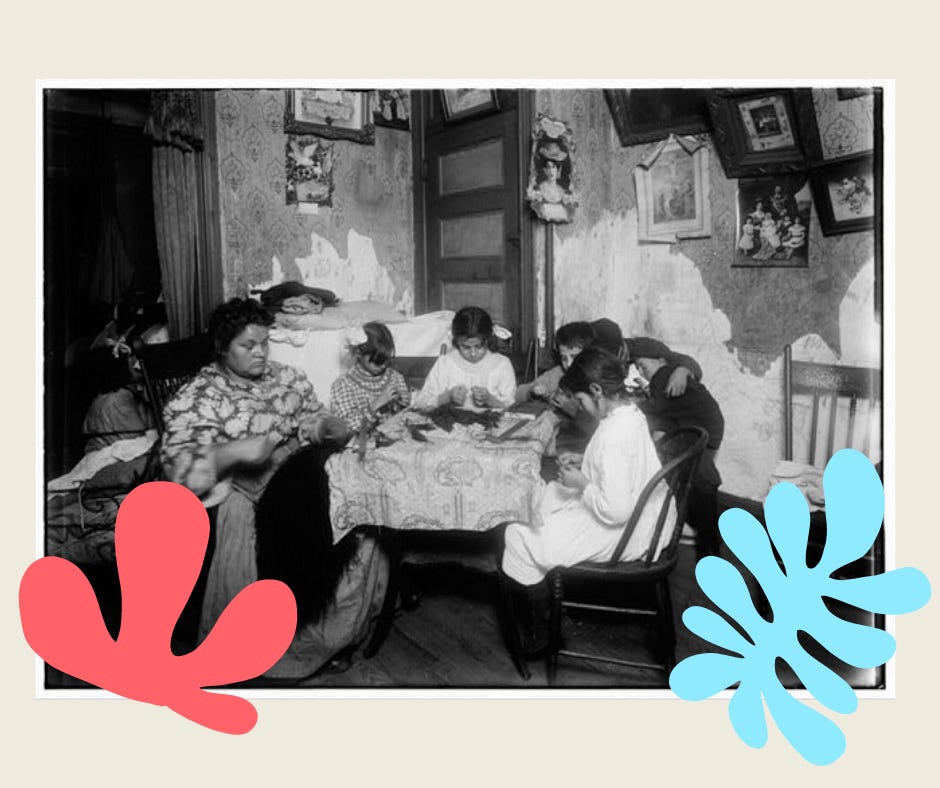 A mother and several children sit around a table in a tenement apartment. The scene appears old-fashioned; the girls wear hair boys and the woman a long dress and apron. 