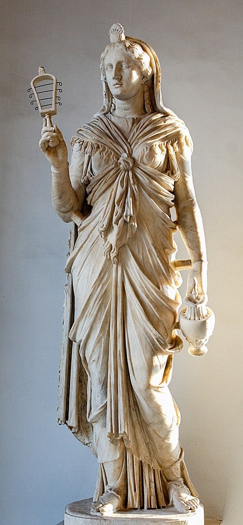 Marble statue of the goddess Isis holding a sistrum and a wine jar