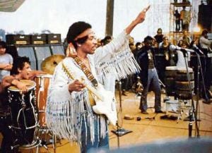 Jimi Hendrix in red, white, and blue on stage at Woodstock, 1969.