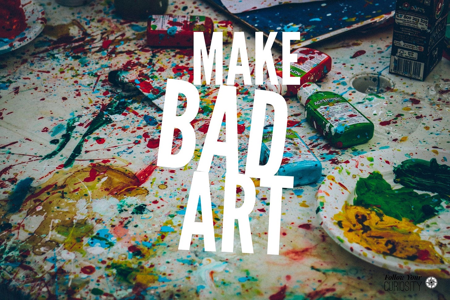 "Make Bad Art" on a background of messy art supplies