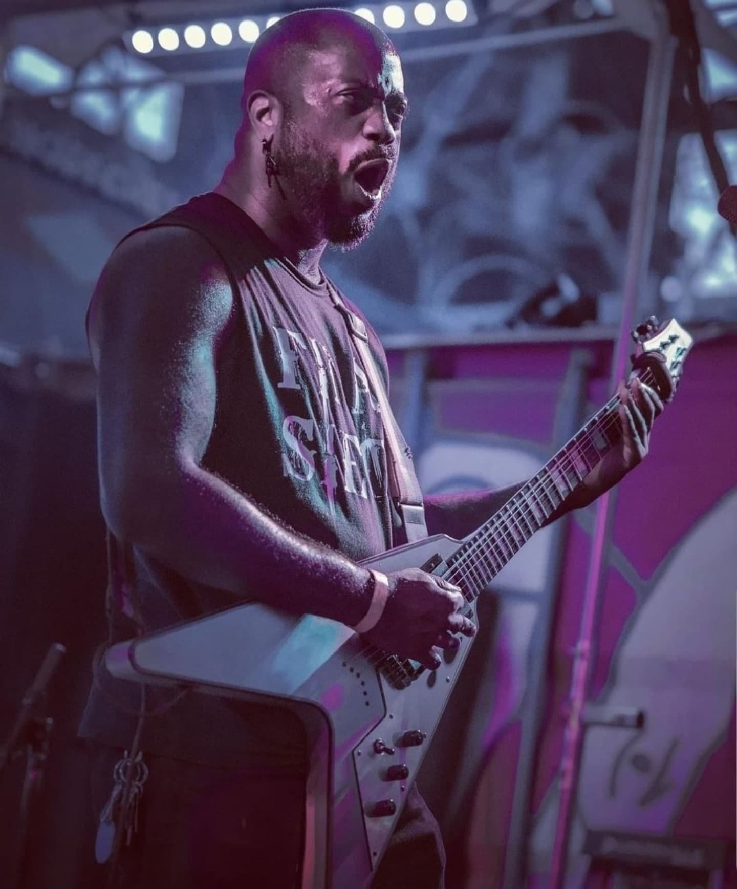 May be an image of 1 person, guitar and text