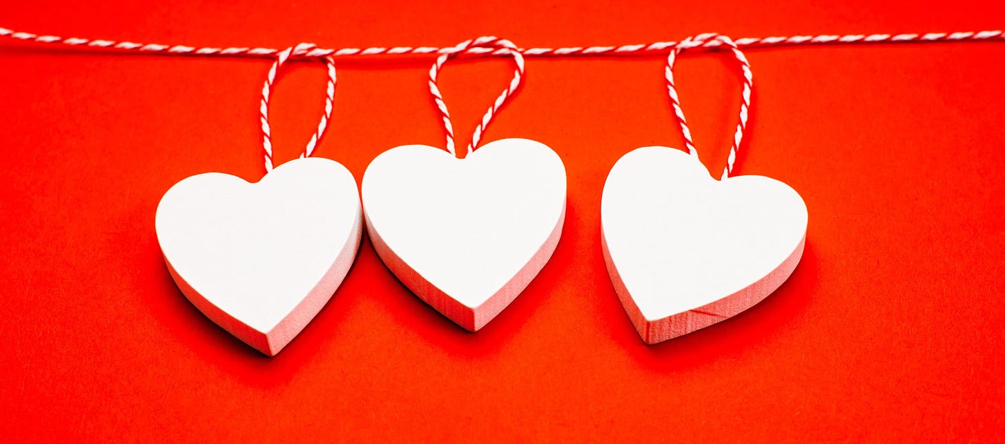 Graphic of three hearts hanging on a clothesline.