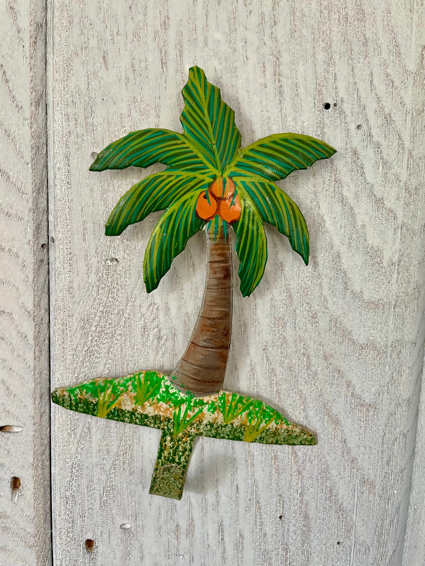 A steel drum palm tree wall hanging made in Haiti.