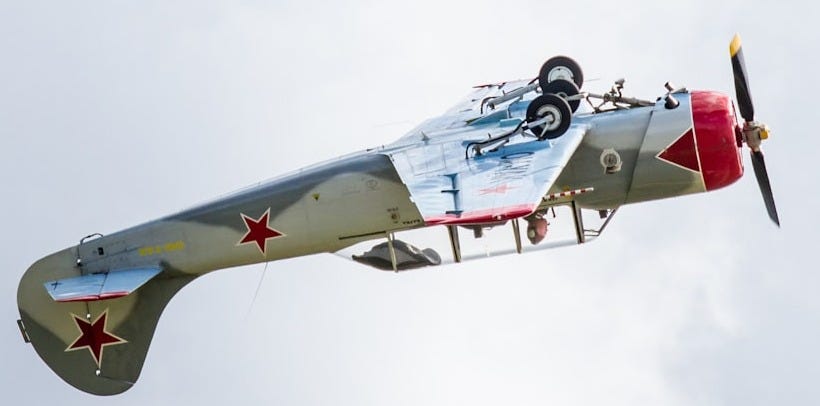 gray and red airplane making a stunt gray and red airplane making a stunt