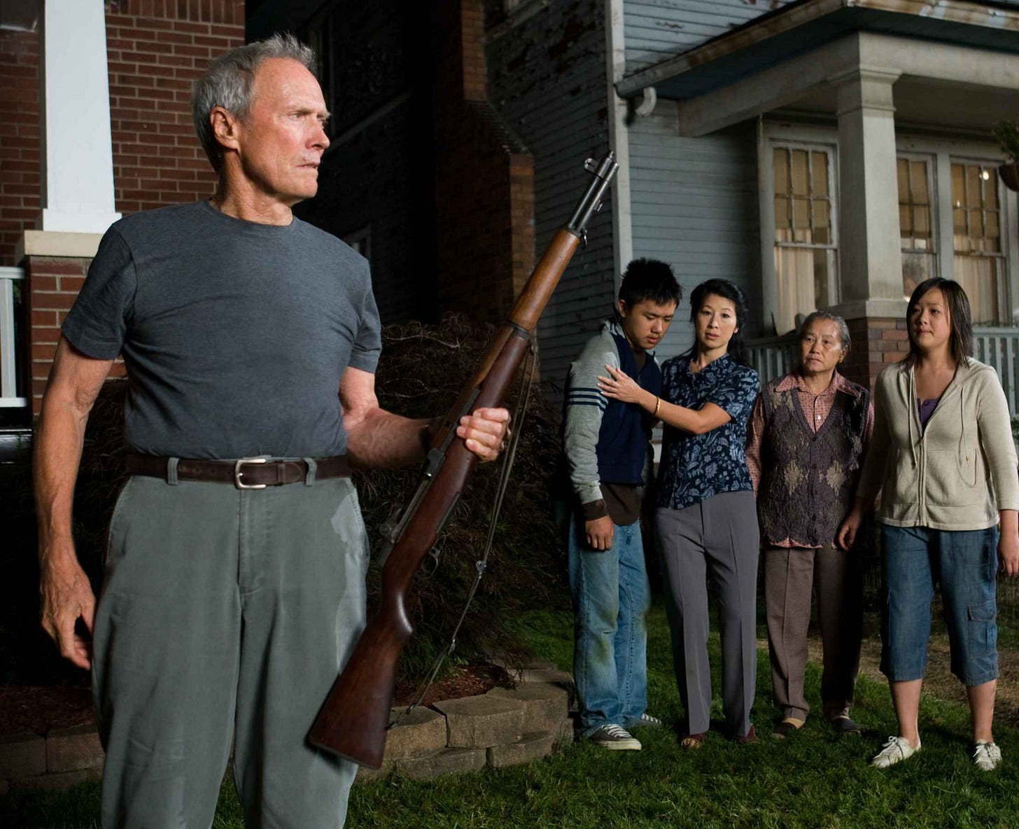 The Hmong family and Clint Eastwood as Walt Kowalski in Gran Torino (2008) directed by himself ...