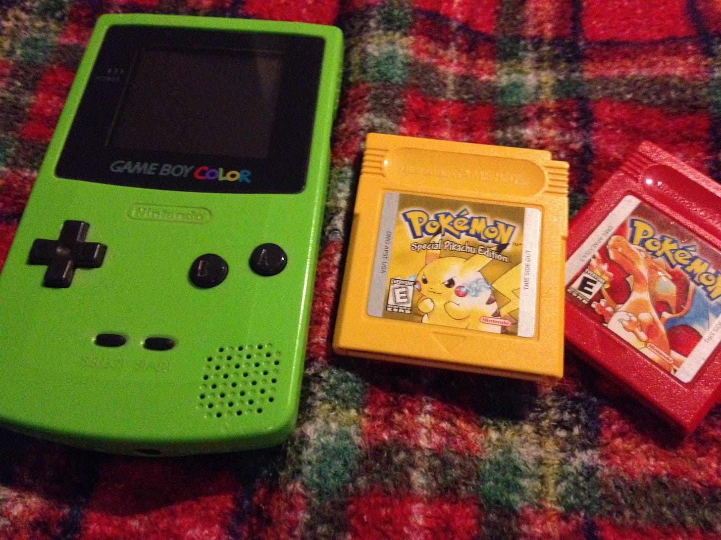 A photograph of Justin’s lime green Game Boy Color and his Pokémon Yellow cartridge (and Red), which still work, twenty-five years after he first received them.