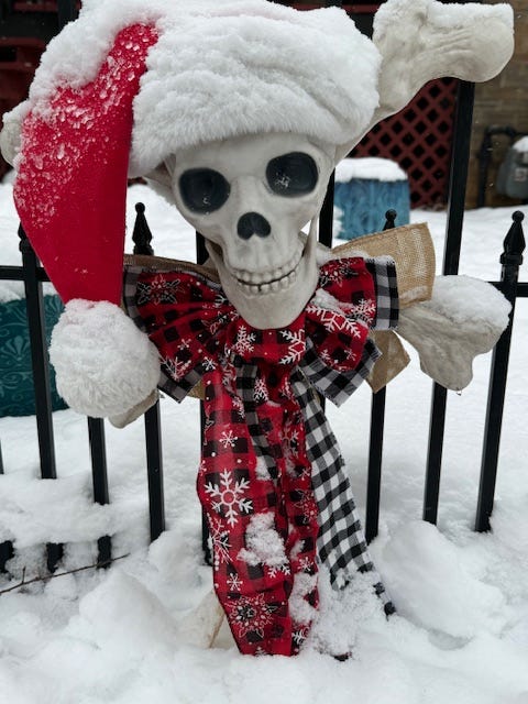 Snow on top of a Halloween skull that's been topped by a Santa cap