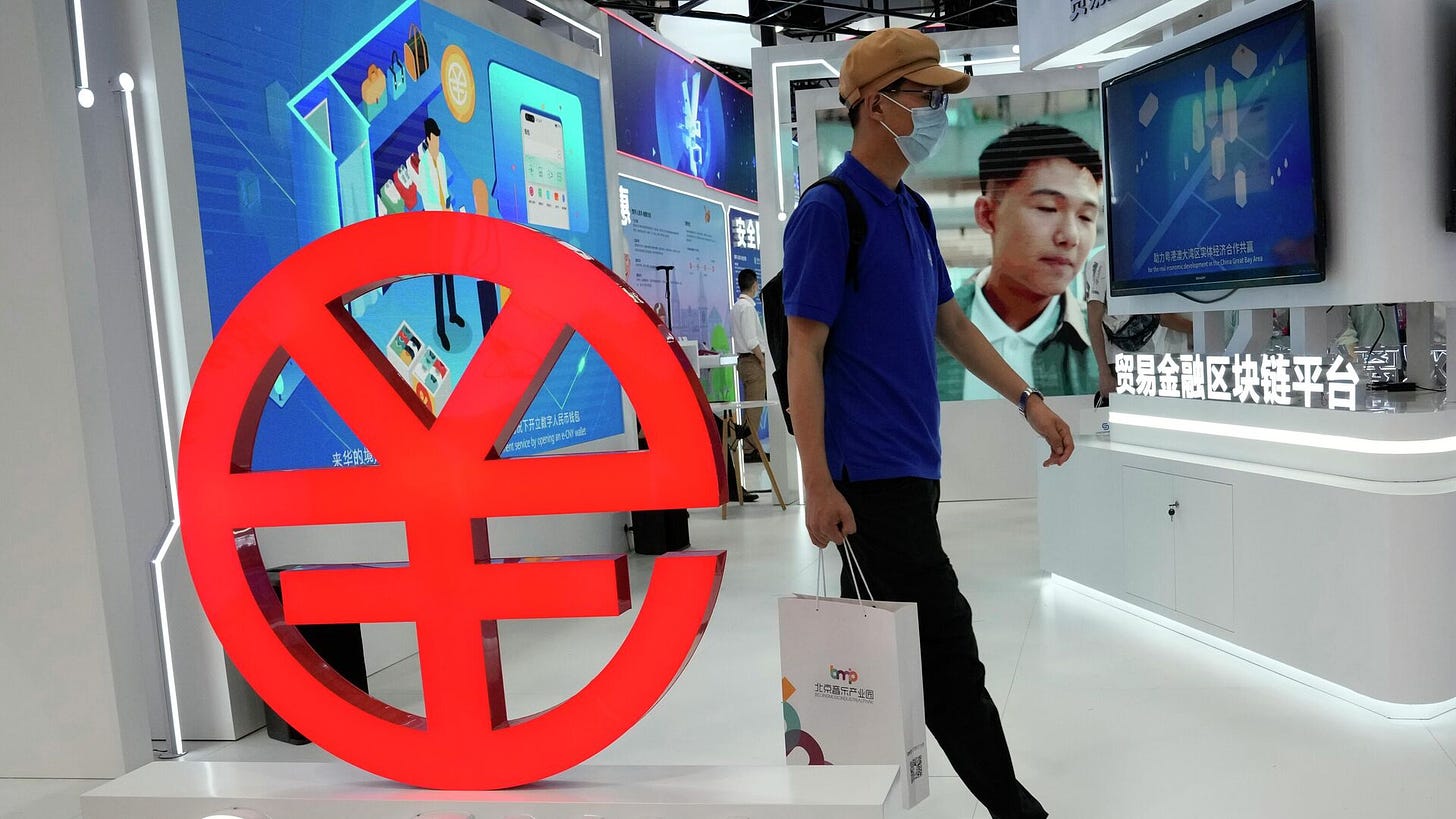 A visitor passes by a logo for the e-CNY, a digital version of the Chinese Yuan, displayed during a trade fair in Beijing, China, Sunday, Sept. 5, 2021 - Sputnik International, 1920, 28.10.2023