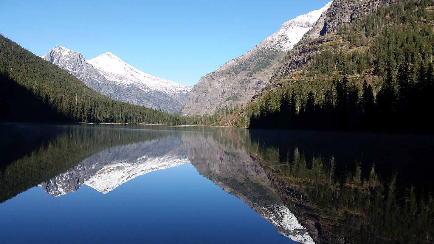 snow-topped ridge reflected in mountain lake