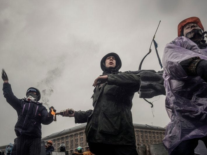 Anti-government protesters use Molotov cocktails to hold back police during the Euromaidan protests in Kyiv in ...