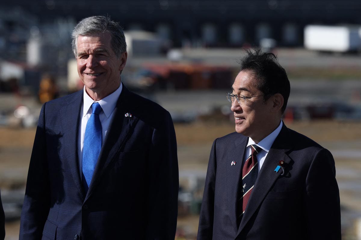 Japanese Prime Minister Fumio Kishida poses with North Carolina Governor Roy Cooper during a tour of the new Toyota battery factory in Liberty, North Carolina, in 2024.