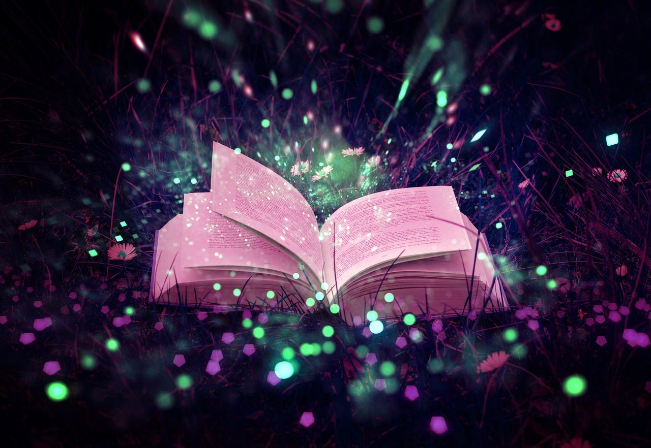 An open book surrounded by colourful fairy lights in green and pink