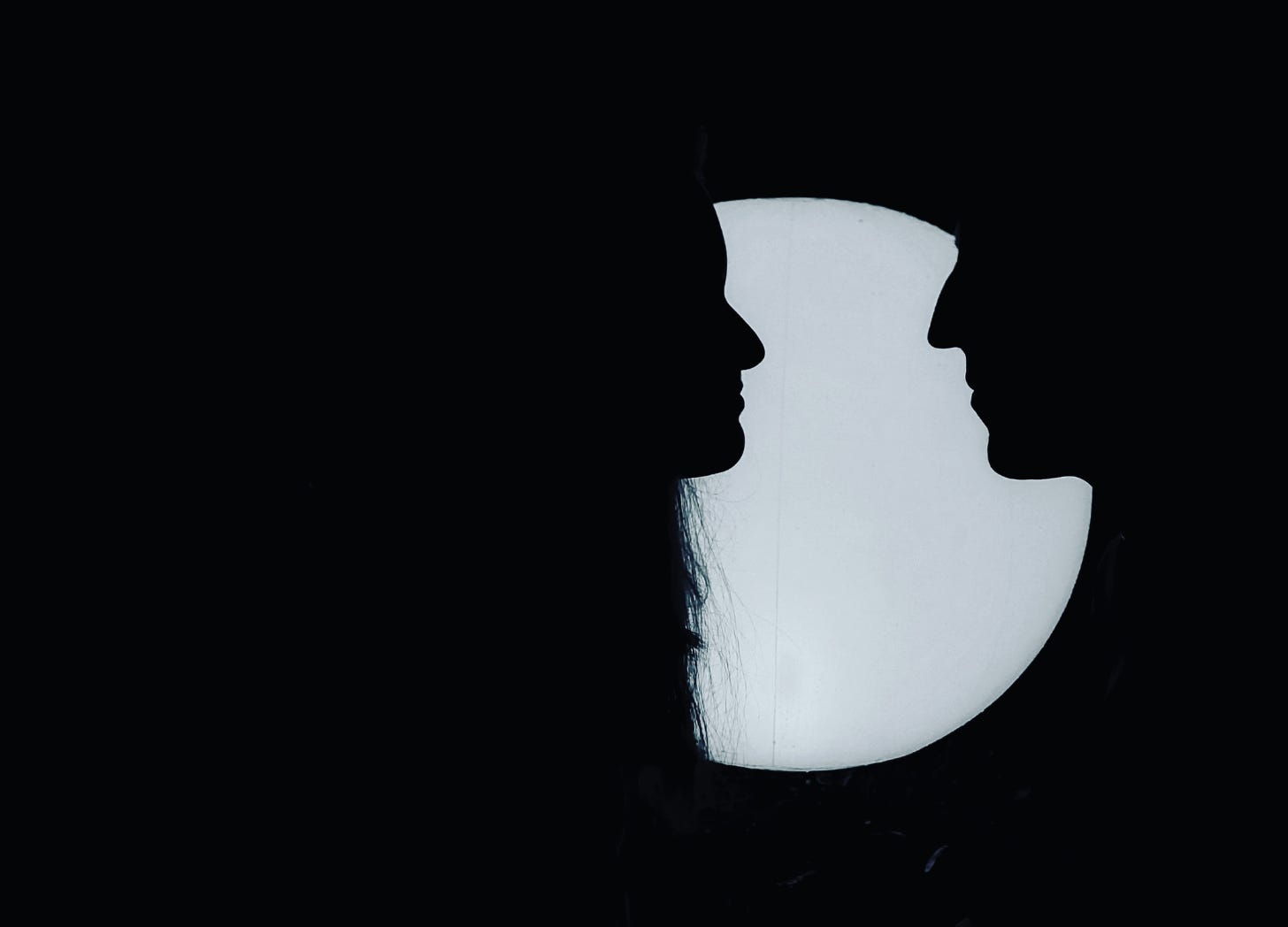 Silhouettes of a man and a woman facing each other 