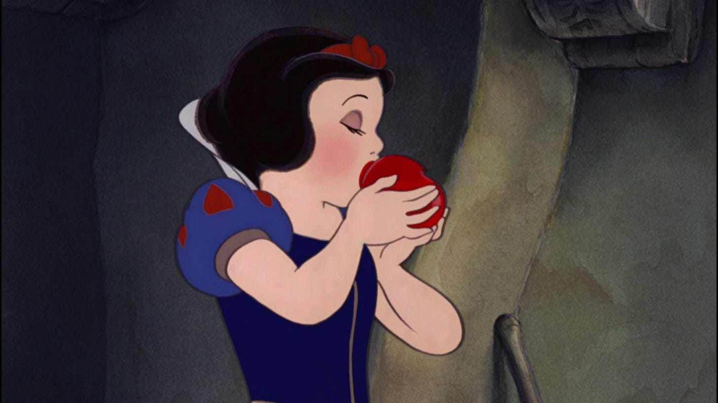 The orginal Disney snow white. She has black hair and has her eyes closed as she bites into a red juicy apple.