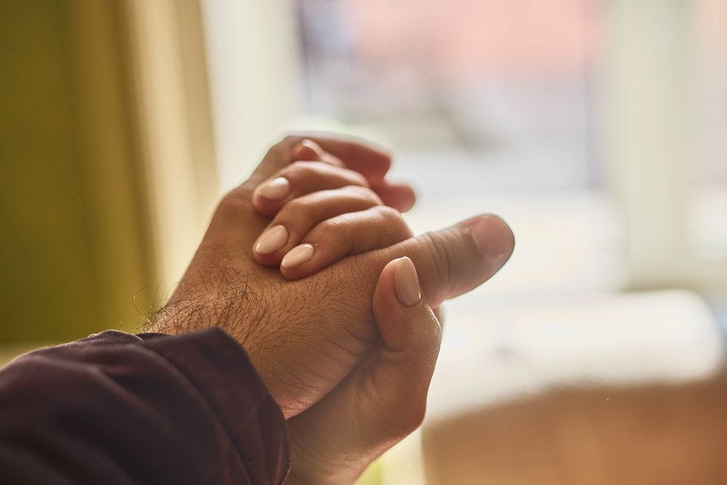 Helping hands. Close-up view of two unrecognizable people holding hands ...