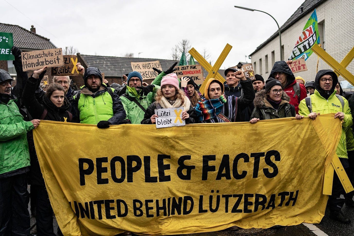 Environmental activists stage a demonstration close to the village of Luetzerath, in Keyenberg, on Thursday. | BLOOMBERG